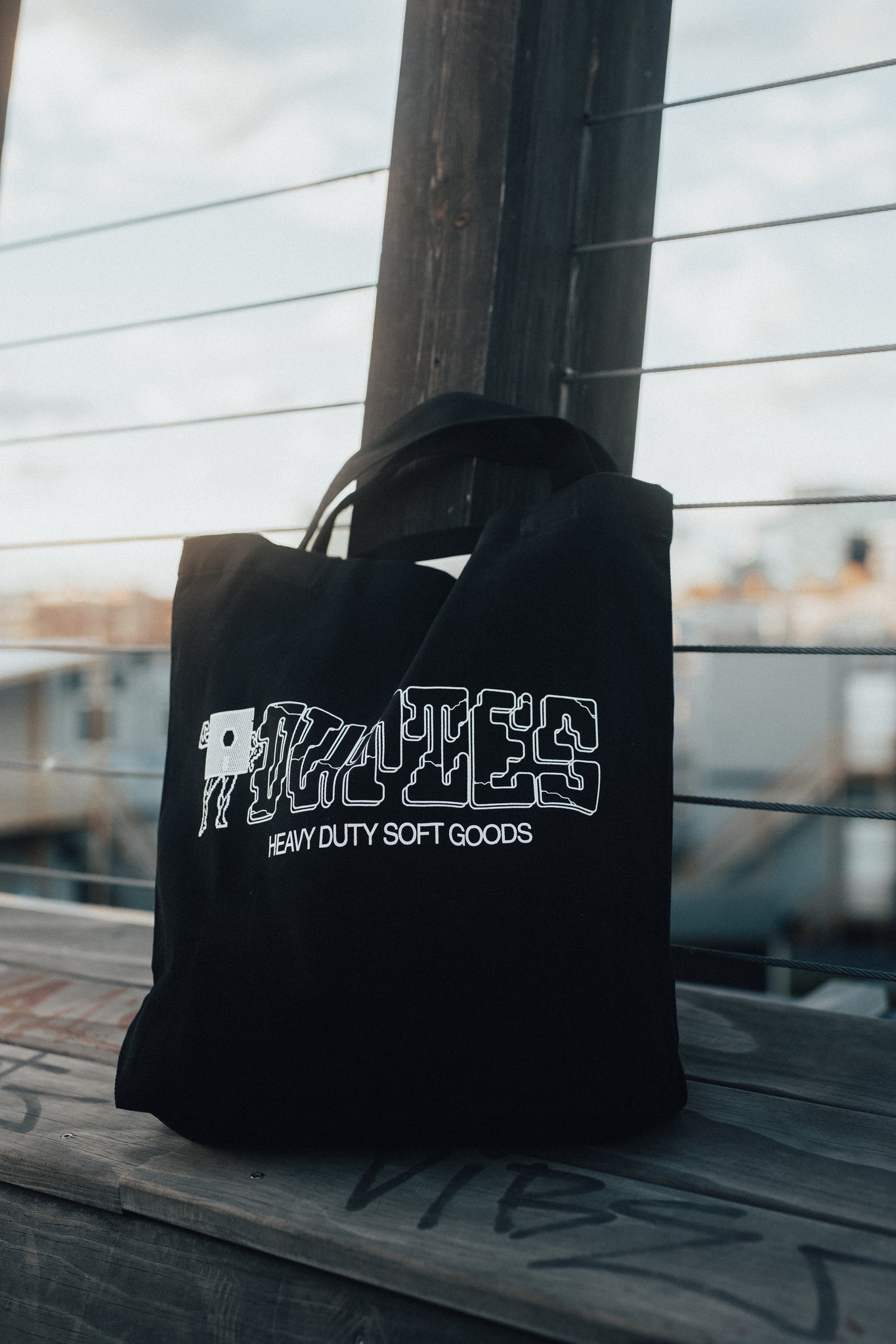 Outside photo of the black Duties Tuff Tote with white printed graphics.