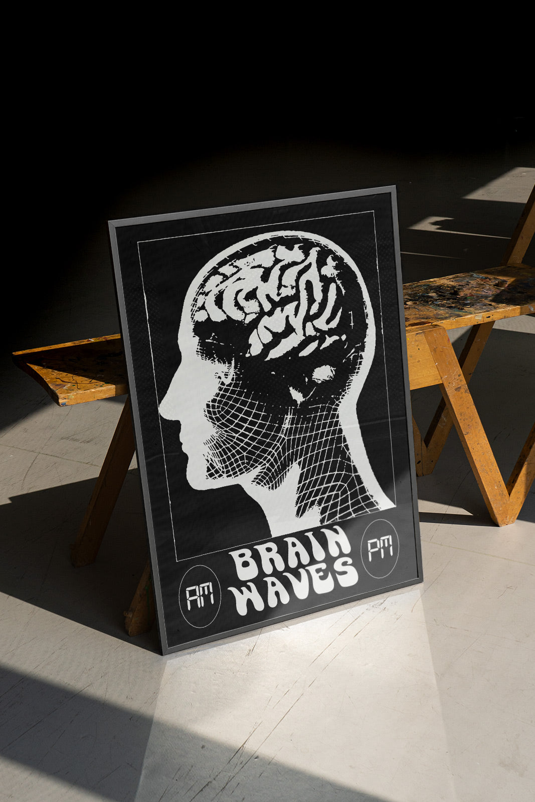 Framed Duties Brain Waves print poster featuring a black and white illustration of a translucent human head, with a text saying 'BRAIN WAVES', standing on a white floor and leaning against a wooden bench.
